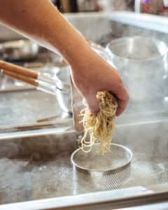 Chef,Cooking,Ramen,Noodles,In,The,Restaurant,Kitchen,,Side,View,