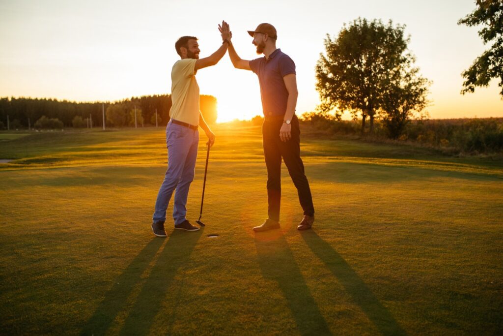 Shot,Of,Two,Golfers,Giving,High,Five,On,The,Golf