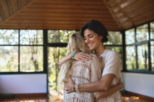 Happy,Female,Holistic,Coach,Hugging,Young,Woman,During,Spiritual,Practice