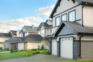 Street,With,Two storied,Brown,Cottages,With,Built in,Garage.,Green,Grass