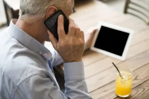 close up old man talking phone scaled 1 1